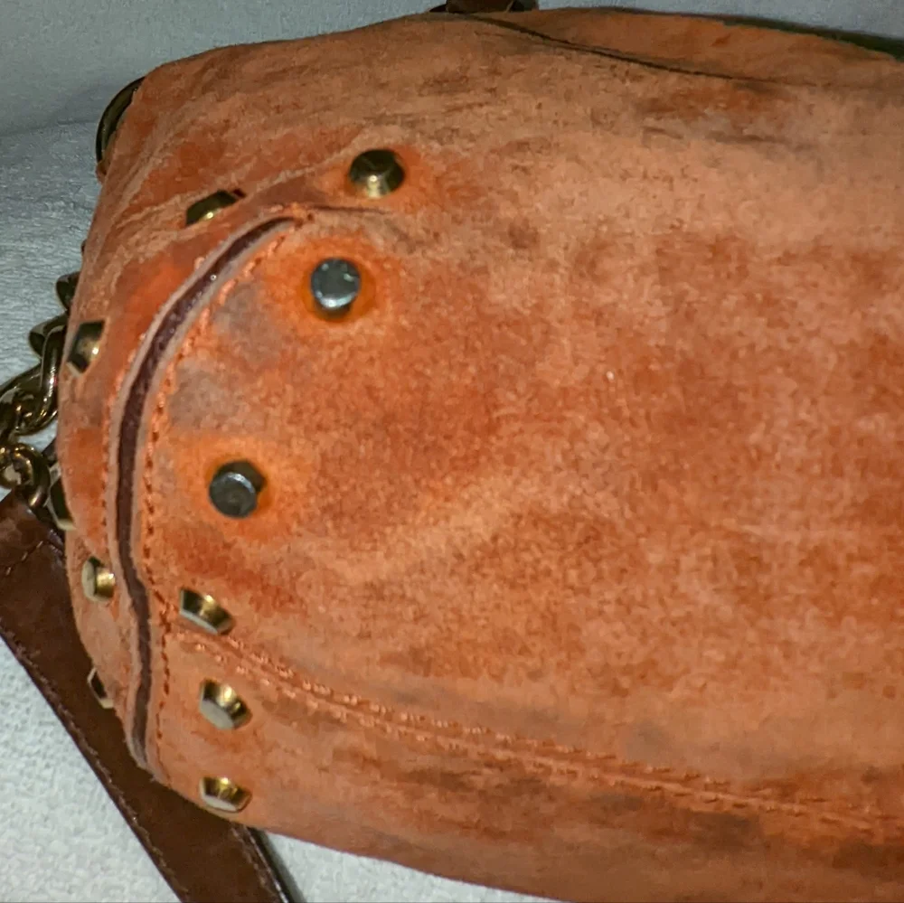 Michael Kors orange suede studded slouchy shoulder bag.